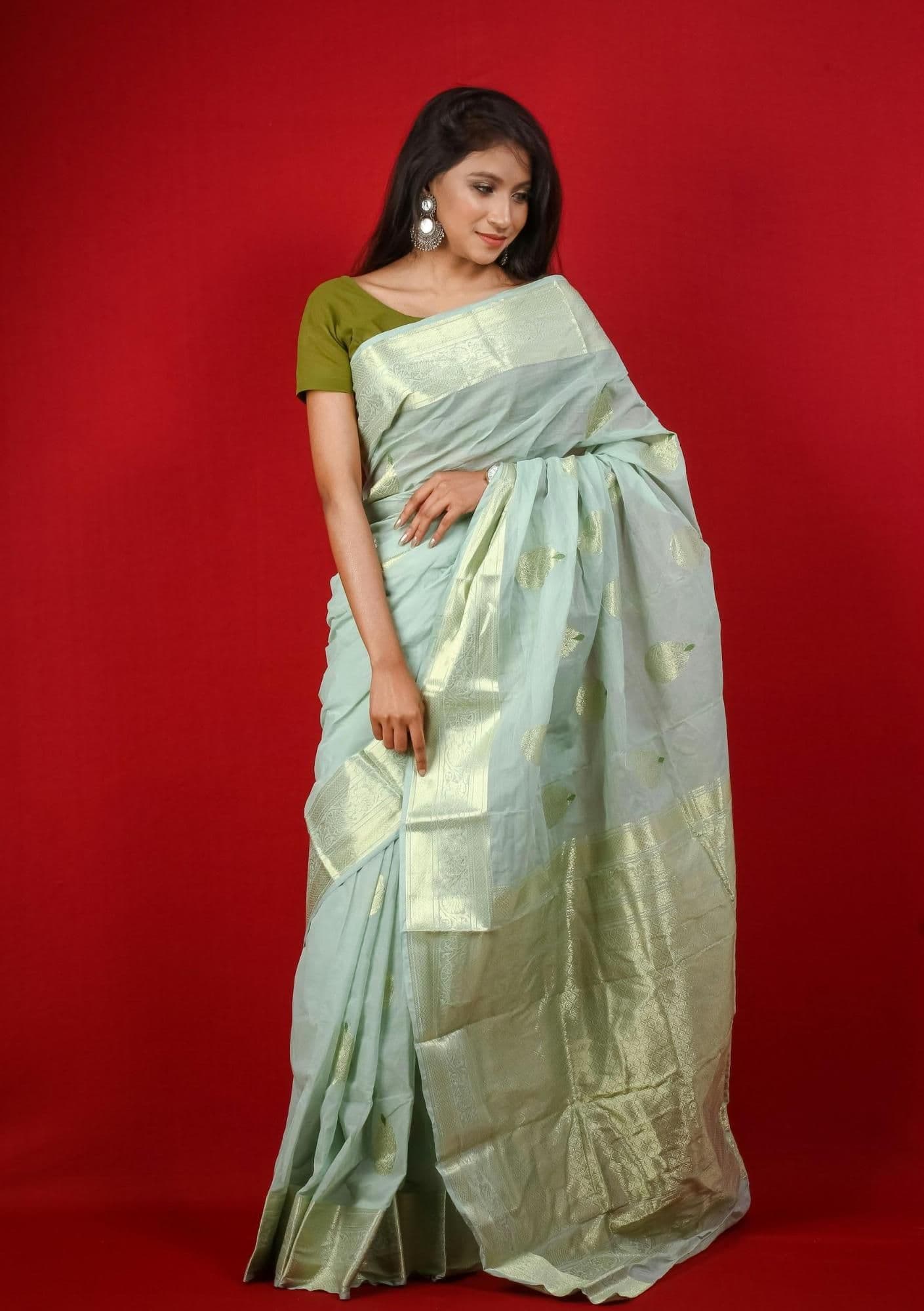 Woman in a saree red carpet photoshoot.