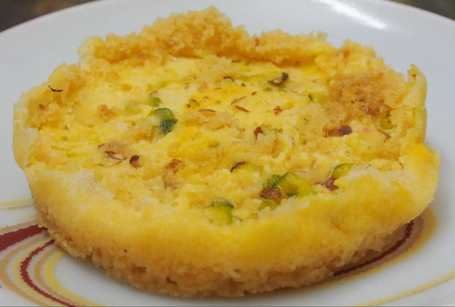 Malai Ghevar garnished with almonds