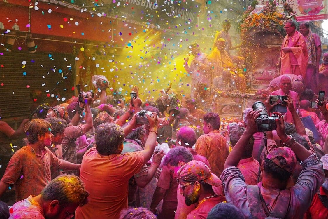People in a parade during the Holi festival in West Bengal
