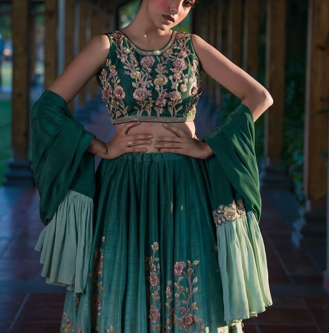 Woman in ornate green dress with dramatic